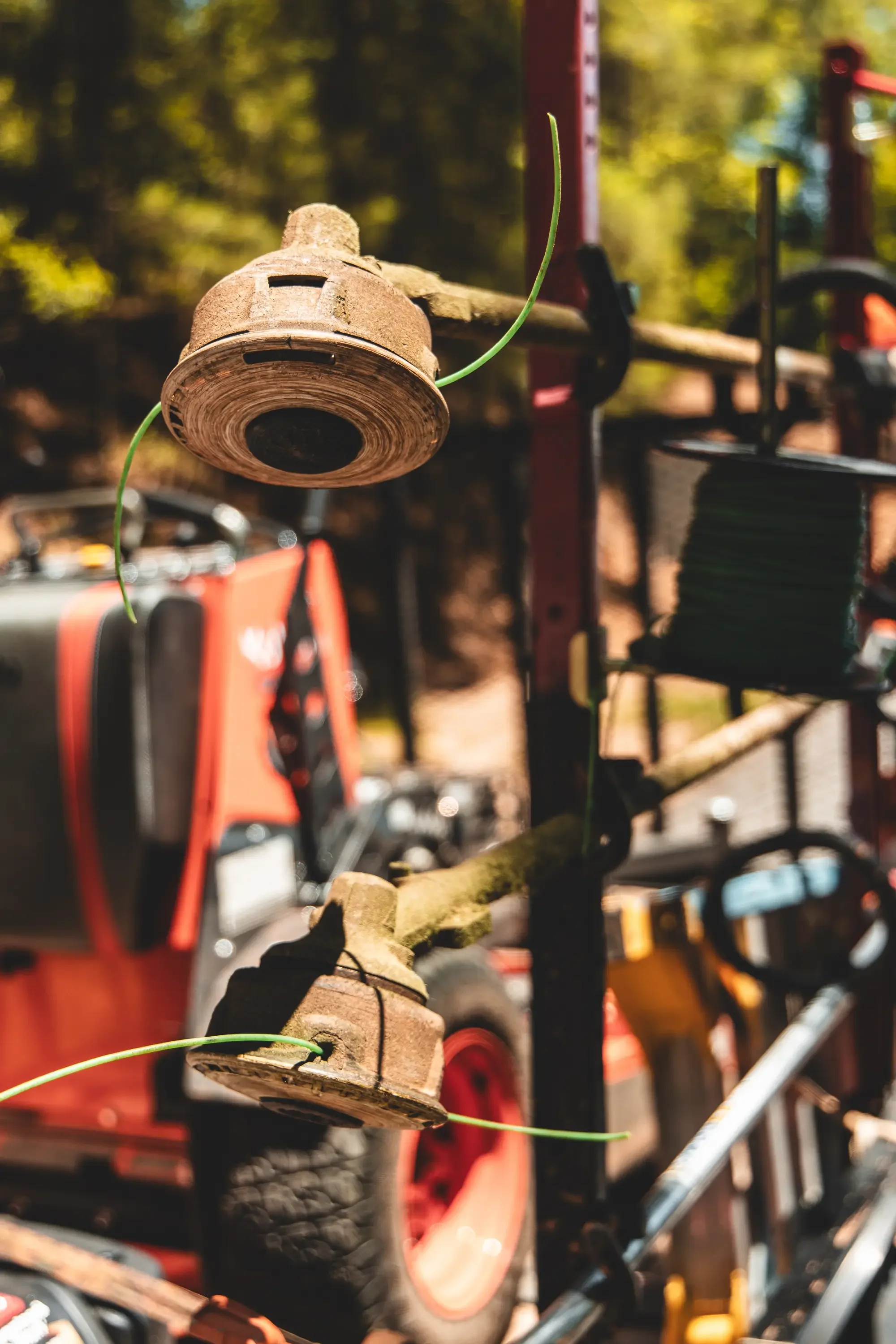 Cork trimmer head with green string line on landscaping equipment